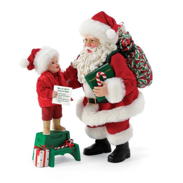 Young child with wishlist pulling Santas beard